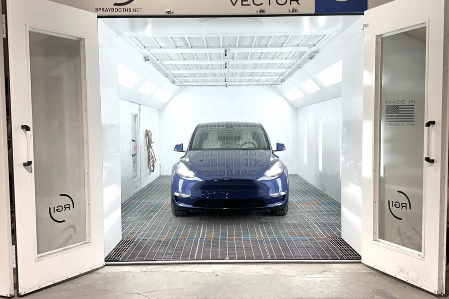 Blue Tesla Model Y inside RGI Vector paint booth at EV Central Service best EV collision repair Bay Area San Francisco