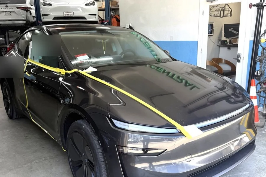 Dark Tesla Model Y with prep tape at EV Central Service EV collision repair shop near San Leandro Alameda Bay Area
