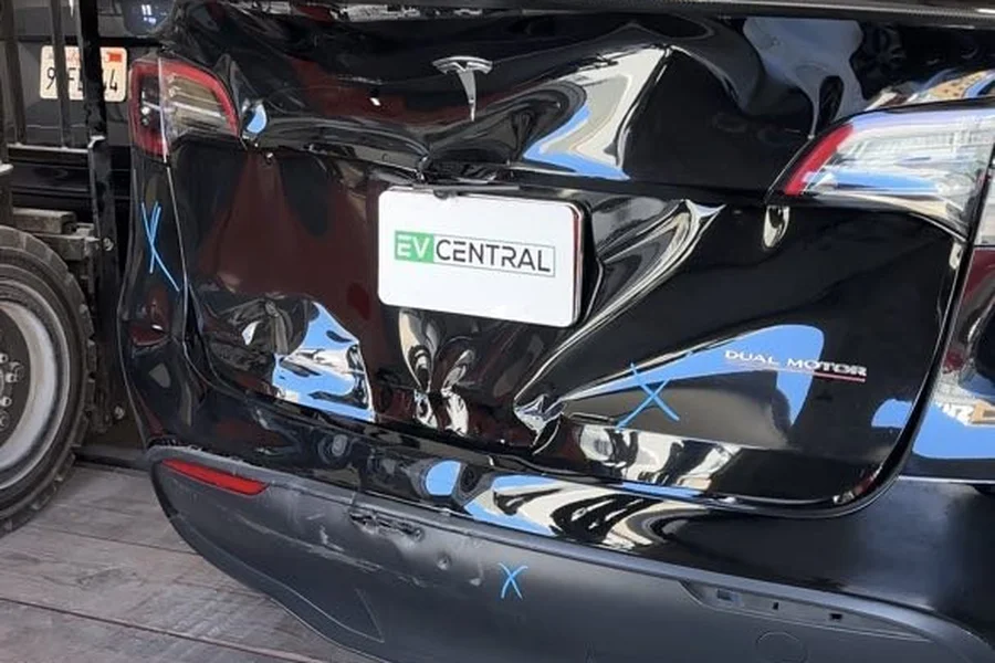 Black Tesla Model Y with rear collision damage at EV Central Service EV collision repair near South San Francisco