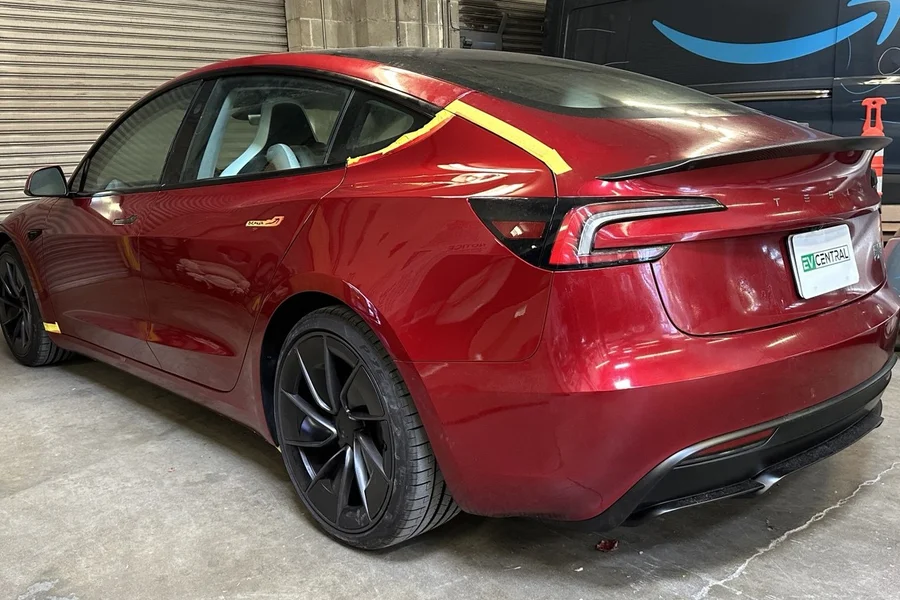 Red Tesla Model 3 Highland with prep tape at EV Central Service collision repair near Daly City San Francisco