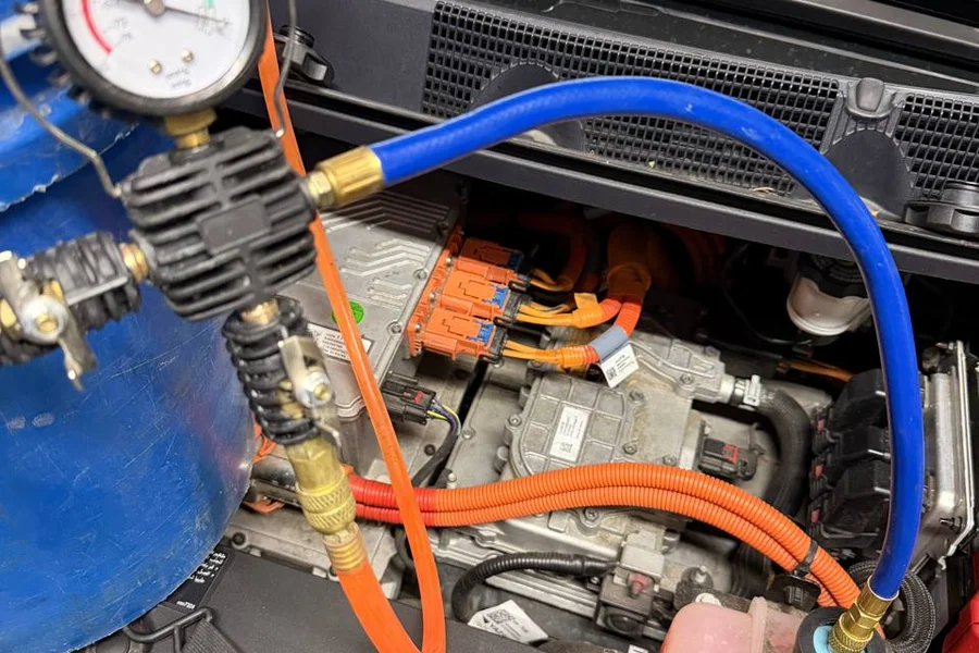 Tesla coolant system pressure test with diagnostic hoses and gauge at EV Central Service San Francisco