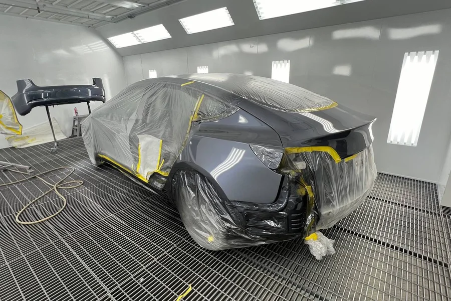 Tesla Model 3 masked and prepped in paint booth at EV Central Service San Francisco