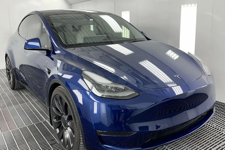 Blue Tesla Model Y finished in paint booth at EV Central Service Tesla repair shop near Burlingame and Hillsborough