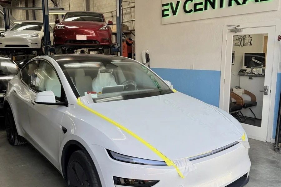 White Tesla Model Y with protective tape at EV Central Service shop serving Fremont and East Bay collision repair