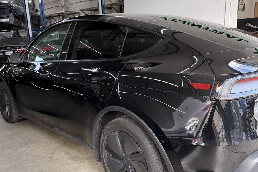 Black Tesla with body damage at EV Central Service independent Tesla service center alternative near Fremont Bay Area