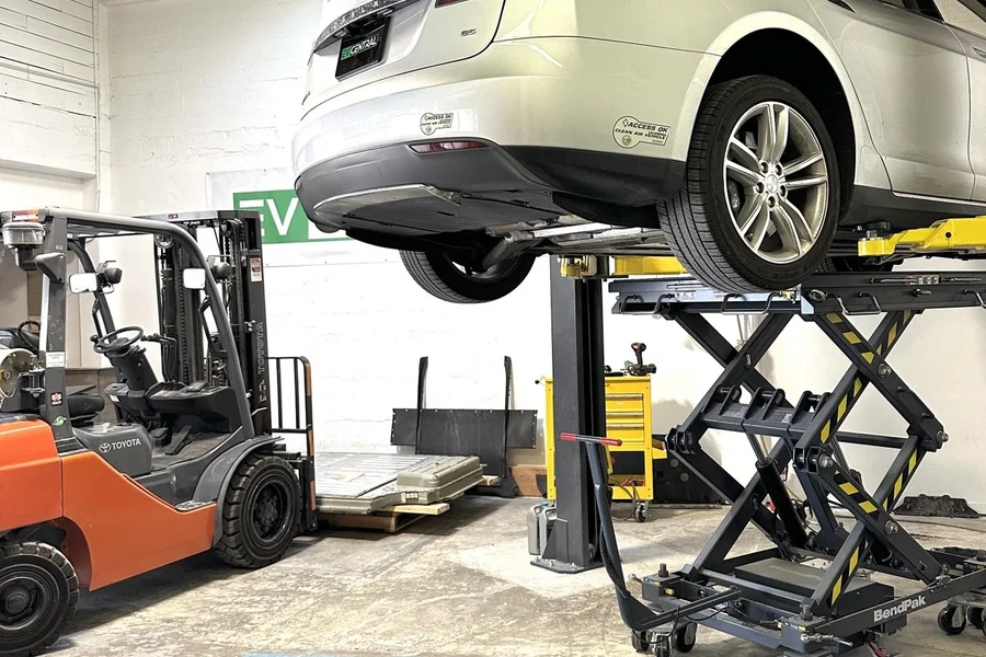 White Tesla Model S on BendPak lift at EV Central Service independent Tesla service center alternative near Redwood City