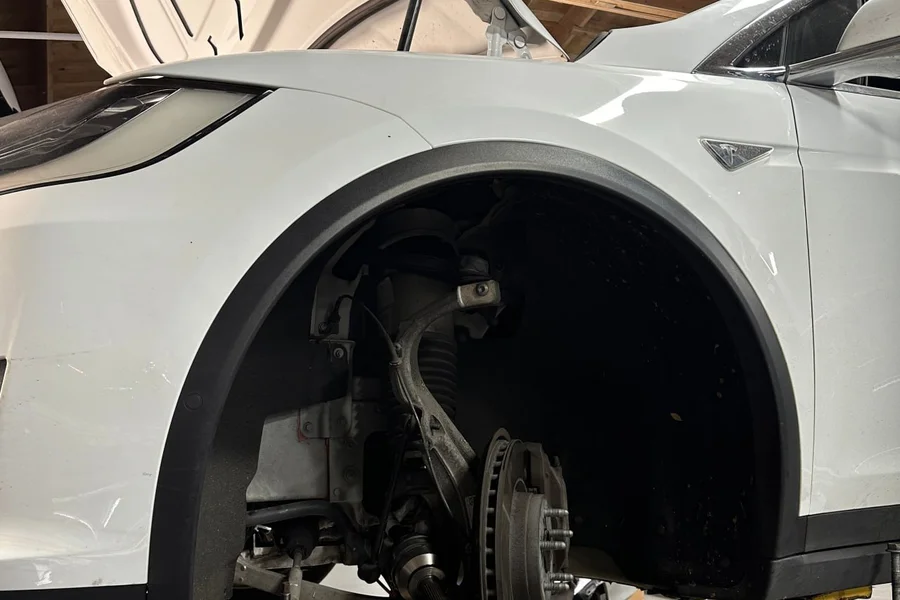 Tesla suspension and control arm repair with wheel removed at EV Central Service San Francisco