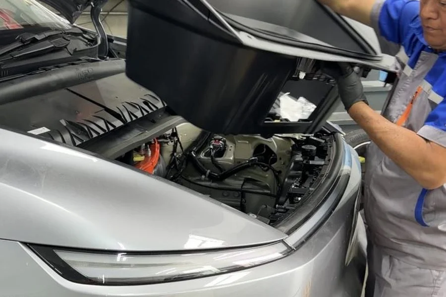 EV Central Service technician opening Polestar 2 frunk for service inspection in San Francisco Bay Area